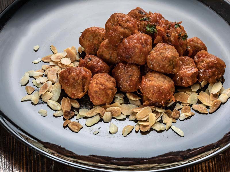 Sweet and sour meatballs with toasted almonds